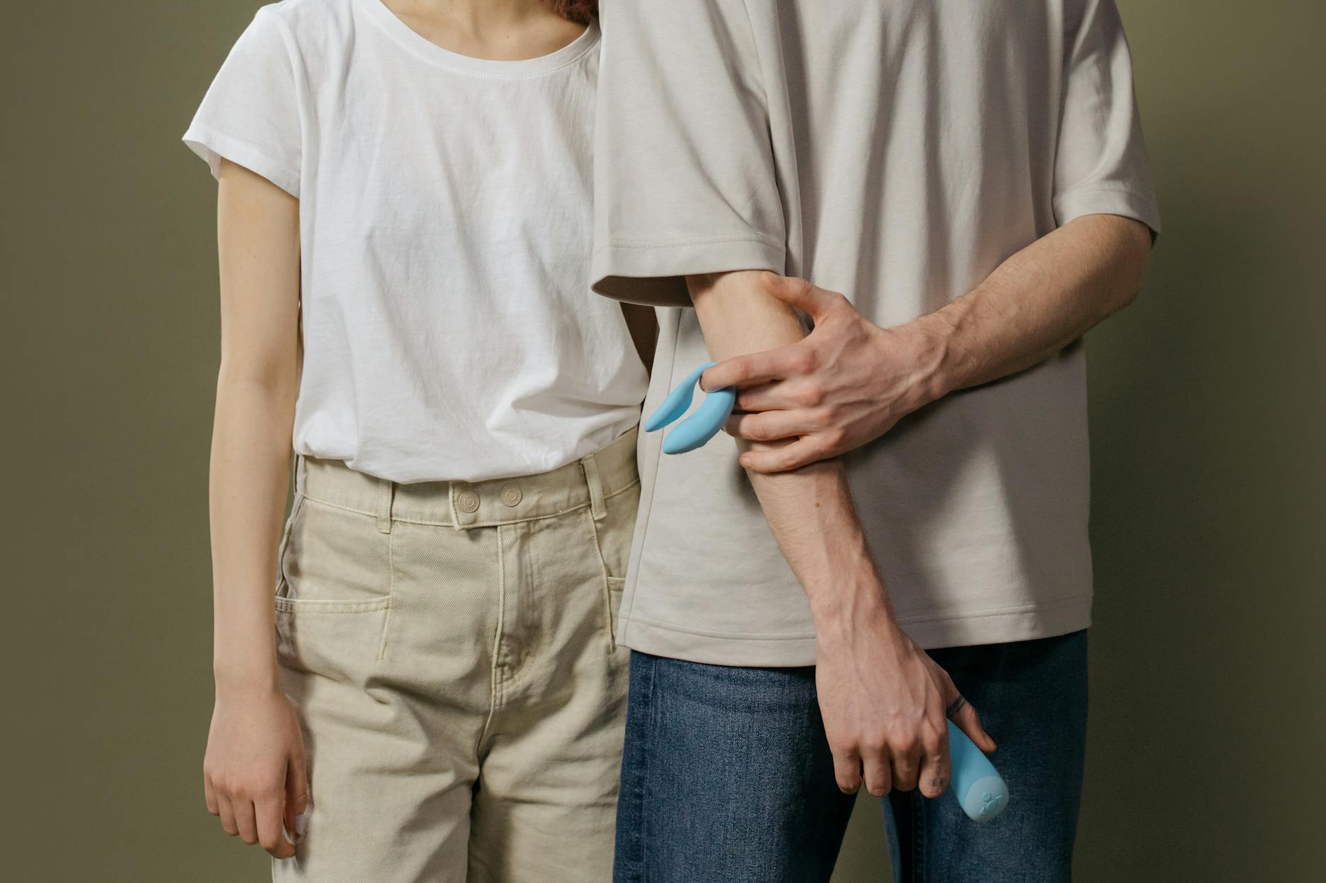 A couple holding a blue lemon vibrator together, symbolizing intimacy and communication